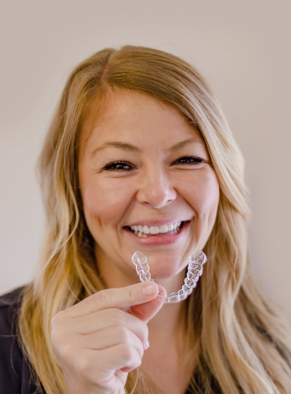 woman holding clear retainer