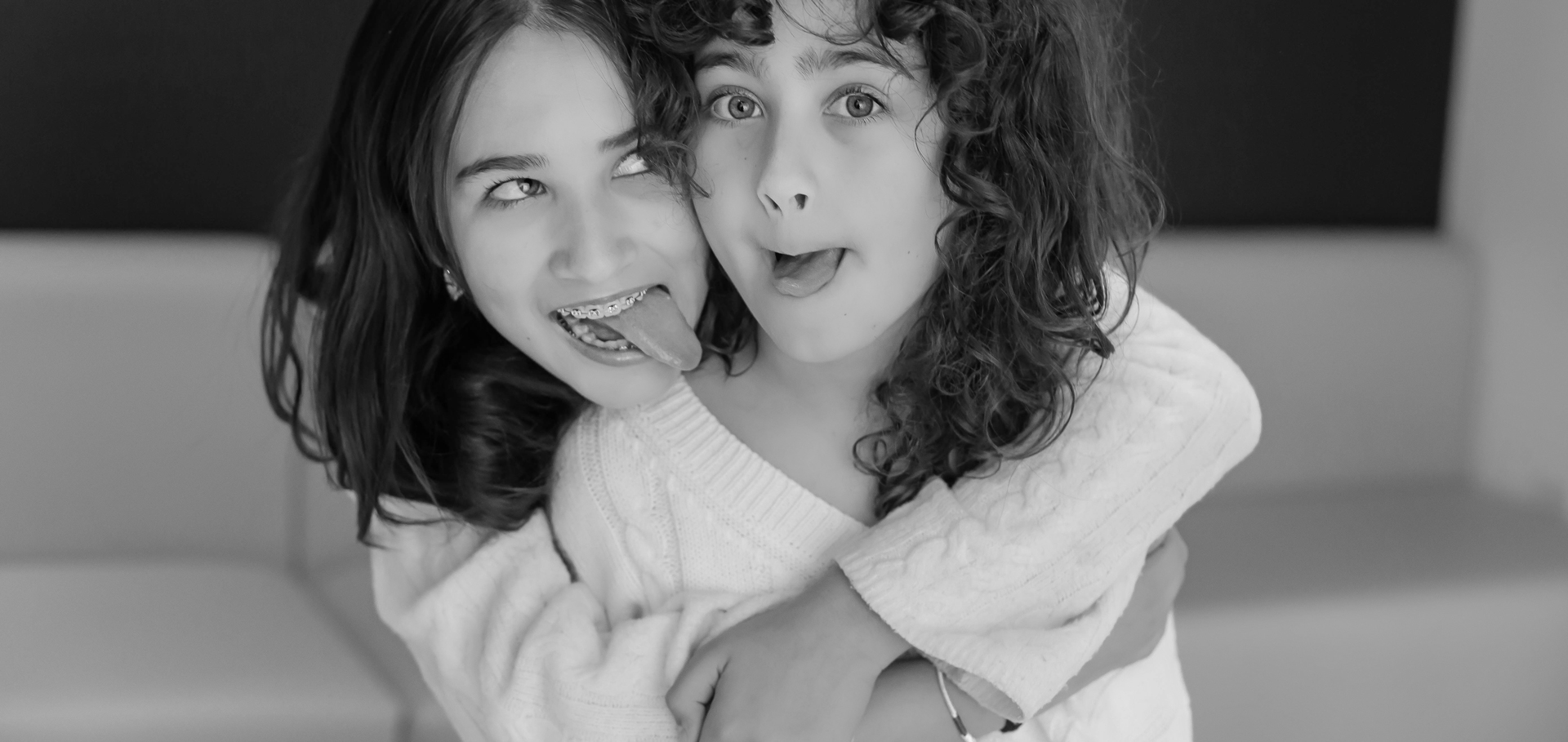 smiling young girls making faces at camera