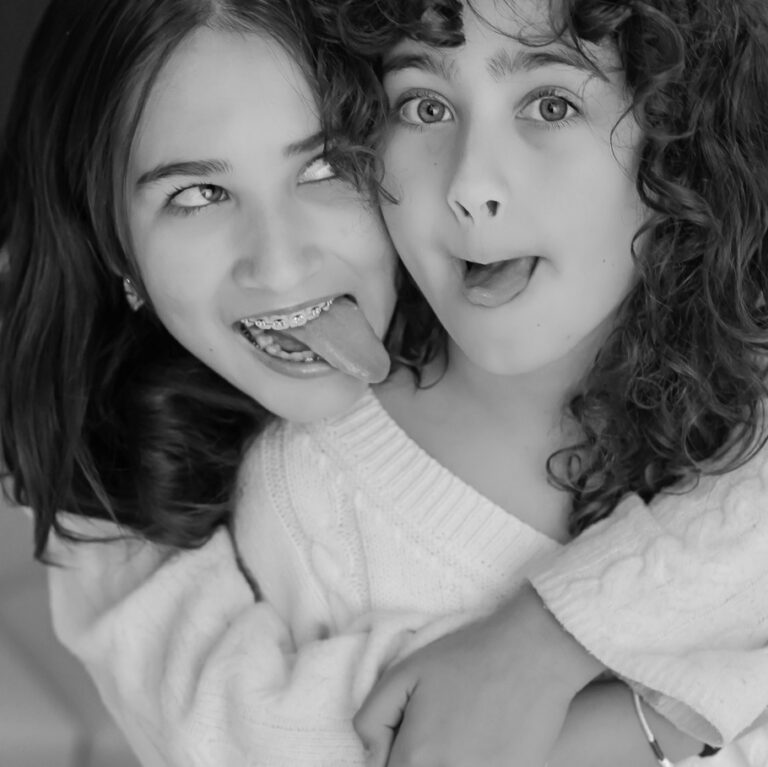 smiling young girls making faces at camera